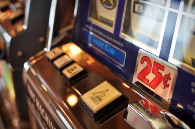 Mobile phone displaying lonceng toto slot game interface with reels and spin button